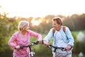 Beautiful senior couple with bicycles outside in spring nature. Royalty Free Stock Photo