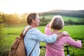 Beautiful senior couple with bicycles outside in spring nature. Royalty Free Stock Photo