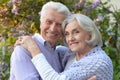 Beautiful senior couple by lilacs in the park Royalty Free Stock Photo