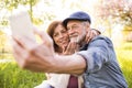 Senior couple with smartphone outside in spring nature. Royalty Free Stock Photo