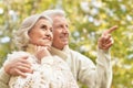 Beautiful senior couple in the park. Man pointing with finger Royalty Free Stock Photo