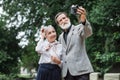 Senior family taking selfie on retro camera at park Royalty Free Stock Photo