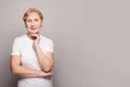 Beautiful senior lady smiling and looking at camera on white background. Mature woman 60s portrait Royalty Free Stock Photo