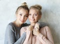 Beautiful senior mom and her adult daughter are hugging, looking at camera and smiling Royalty Free Stock Photo