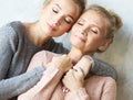 Beautiful senior mom and her adult daughter are hugging, looking at camera and smiling. At Home Royalty Free Stock Photo