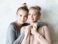 Beautiful senior mom and her adult daughter are hugging, looking at camera and smiling. Royalty Free Stock Photo