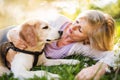 Beautiful senior woman with dog in spring nature. Royalty Free Stock Photo