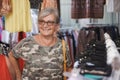 Beautiful senior woman enjoying shopping at city market, looking for clothes. Smiling caucasian people, happy expression Royalty Free Stock Photo