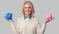 Senior woman holding two piggy banks Royalty Free Stock Photo