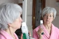 Beautiful senior woman using mouthwash Royalty Free Stock Photo