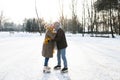 Senior couple in sunny winter nature ice skating. Royalty Free Stock Photo