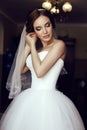 Beautiful sensual bride with dark hair in luxurious lace wedding dress