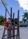 Beautiful and sensual lifeguard sexily observing the sea with yellow flag and ready with lifeguard. baywatch