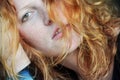Beautiful sensual portrait in closeup of a thoughtful young redhead wistful