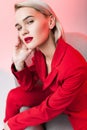 beautiful sensual stylish woman in red clothes posing in armchair Royalty Free Stock Photo