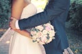 Beautiful sensual wedding couple and gentle bouquet of flowers