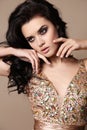 Beautiful sensual woman with dark hair with bijou in luxurious dress Royalty Free Stock Photo