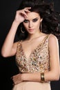 Beautiful sensual woman with dark hair with bijou in luxurious dress Royalty Free Stock Photo