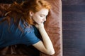 Beautiful sensual woman sleeping on brown leather sofa Royalty Free Stock Photo