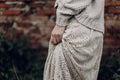 Beautiful sensual woman in stylish boho indie clothes, wool sweater and white lace dress, hands closeup Royalty Free Stock Photo