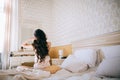 Beautiful sensual young bride in bedroom. Last preparations for the wedding. Bride waits for her groom. Wedding morning