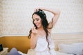 Beautiful sensual young bride in bedroom. Last preparations for the wedding. Bride waits for her groom. Wedding morning