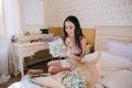 Beautiful sensual young bride in bedroom. Last preparations for the wedding. Bride waits for her groom. Wedding morning