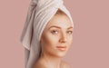 Beautiful sensual young girl with clean skin on a pink background with a mockup. Topless woman in a towel. The concept of spa Royalty Free Stock Photo