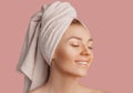 Beautiful sensual young girl with clean skin on a pink background with a mockup. Topless woman in a towel. The concept of spa Royalty Free Stock Photo