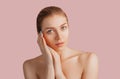 Beautiful sensual young girl with clean skin on a pink background with a mockup. Topless woman. The concept of spa treatments, Royalty Free Stock Photo