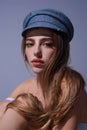 Beautiful sensual young woman in fashion cap hat, close up studio portrait. Beautiful model, sexy girl face. Fashion and Royalty Free Stock Photo