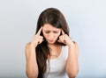 Beautiful serious concentrated woman two fingers holding the face and thinking and looking down in white shirt and long hair.