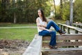 A beautiful serious teen brunette girl looking away from the camera towards the future in a park in the spring Royalty Free Stock Photo