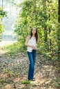 A beautiful serious teen brunette girl looking away from the camera towards the future in a wooded area in the spring Royalty Free Stock Photo