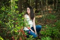 A beautiful serious teen brunette girl looking away from the camera towards the future in a wooded area in the spring Royalty Free Stock Photo