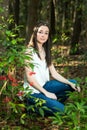 A beautiful serious teen brunette girl looking away from the camera towards the future in a wooded area in the spring Royalty Free Stock Photo