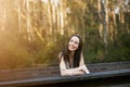 A beautiful serious teen brunette girl looking away from the camera towards the future in a wooded area in the spring Royalty Free Stock Photo