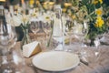 Beautiful served wedding table with decor as candles, flower arrangements. Banquet dinner party. Wine glasses, water Royalty Free Stock Photo