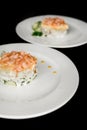 Beautiful serving dish salad under the crooks and garnished with herbs on a 2 two white plate food restaurant on a black Royalty Free Stock Photo