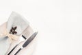 Beautiful set of cutlery knife and fork on a plate on a white wooden table. Royalty Free Stock Photo