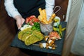 Beautiful set of food in the hands of a young waiter in a restaurant. close-up top view Royalty Free Stock Photo