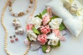 Beautiful set of wedding accessories for the bride. Bride`s morning. Bride`s bouquet of white and pink flowers. Pearl necklace a Royalty Free Stock Photo