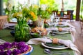 beautiful setting of a large table with flowers. Royalty Free Stock Photo