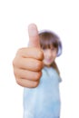 A beautiful seven-year-old girl shows a thumb up on a white background