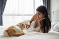 Sexy young woman play with cat on bed in morning Royalty Free Stock Photo