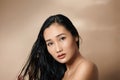 Beautiful sexy asian woman model posing on beige background Royalty Free Stock Photo