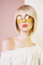 Sensual stylish woman in erotic white dress. Blue-eyed lady with perfect lips in modern colour sunglasses