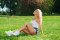 Beautiful blonde woman in blue jeans shorts Royalty Free Stock Photo