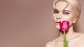 Beautiful sexy Blonde Woman with luxury Make-up. Girl with Spring Flowers Bouquet. Style for Womans Day or Valentines Royalty Free Stock Photo