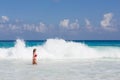 Beautiful and blonde woman in red swimsuit at tropical beach, Seychelles